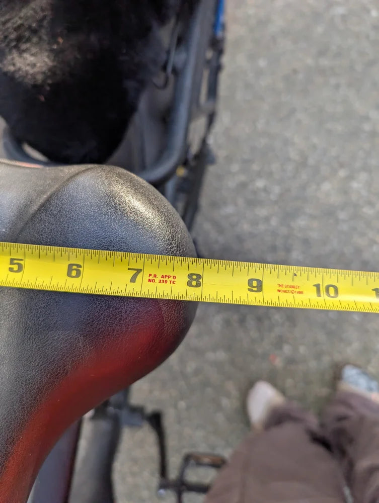Yellow tape measure on merino sheepskin bicycle seat cover