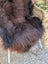 A large plush dark rusty icelandic sheepskin rug with soft fluffy wool and natural shade variations