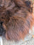 A plush shaggy brown wool icelandic sheepskin blanket in natural dark rusty shades 49 x 31 inches
