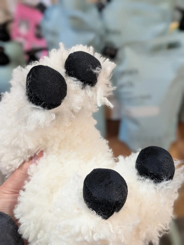 White fluffy paw-shaped accessory with black pads from nana huchy valentina the valais sheep collection