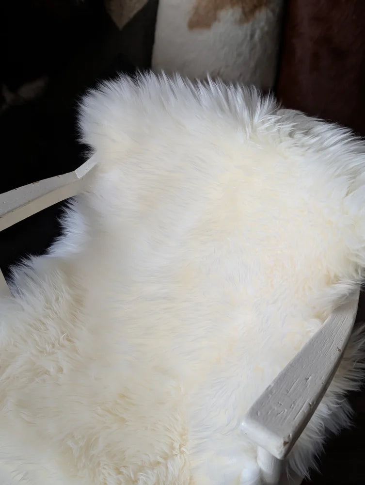White fluffy oeko tex certified merino double sheepskin rug on chair