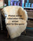Cream-colored washable medical sheepskin chair cover draped over wooden frame large angus oliver style