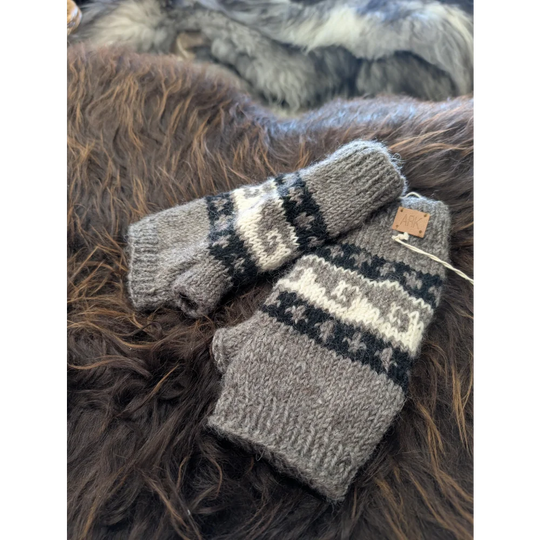 Grey and white Zealand wool wave hand warmers with knitted exterior and leather tag
