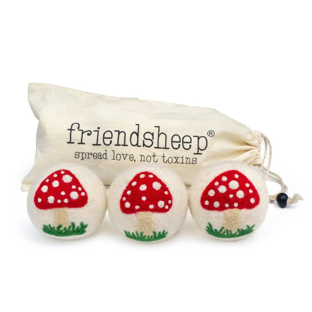 White mushroom trio dryer balls made of white felted wool with red mushroom embroidery by angus oliver