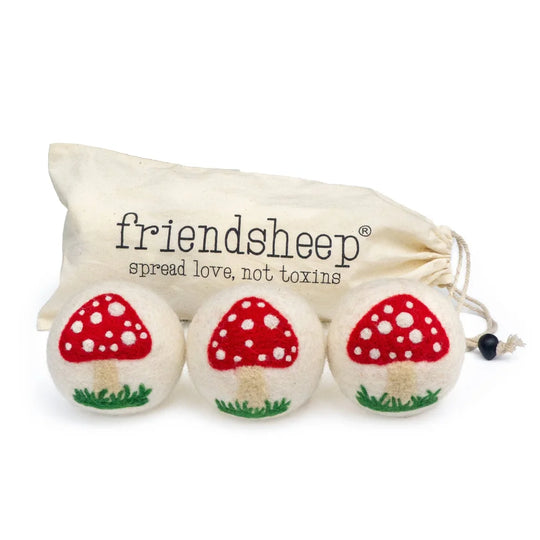 White mushroom trio dryer balls made of white felted wool with red mushroom embroidery by angus oliver
