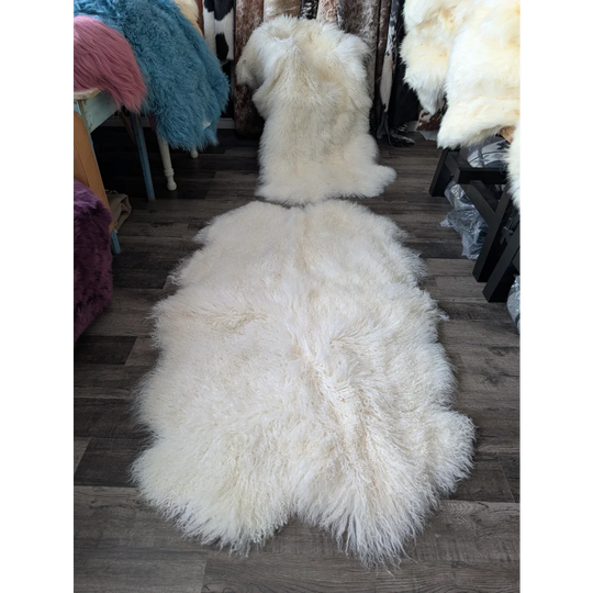 Gorgeous natural white Mongolian sheepskin rug on wood floor