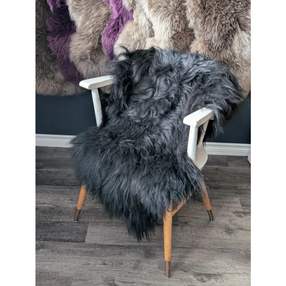 Soft Icelandic sheepskin rug draped over white wooden chair