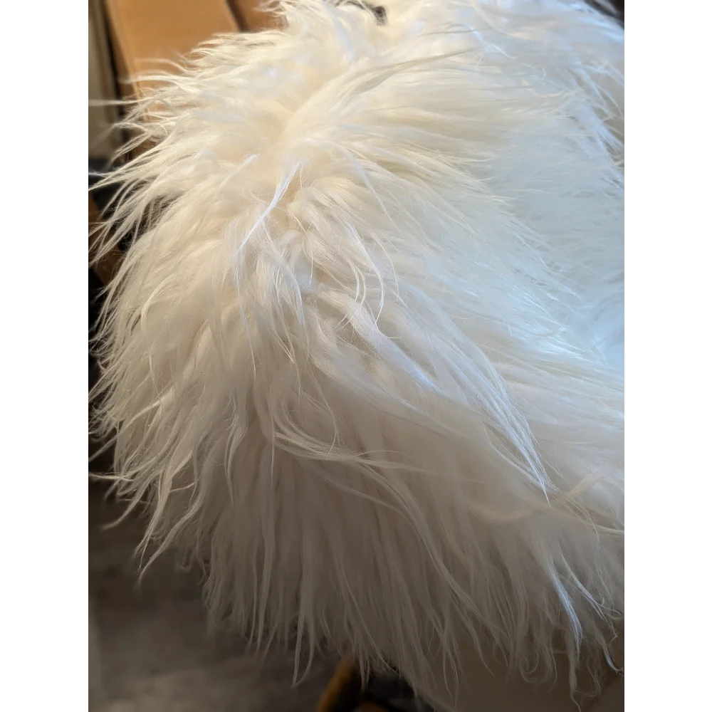 A plush white icelandic sheepskin rug 51 x 33 inches with soft long strands and fluffy texture grade a quality