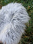A plush gray and white wool icelandic faux fur throw pillow made from long wool icelandic sheepskin fibers