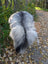 A plush 60 x 32 inch icelandic sheepskin rug with long wool in a natural grey gradient from white to black