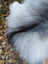 A fluffy long wool icelandic sheepskin rug in natural grey with white and gray mix fur measuring 60 x 32 inches