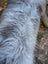 A long shaggy coat of natural grey wool icelandic sheepskin with wiry texture measuring 59 by 35 inches