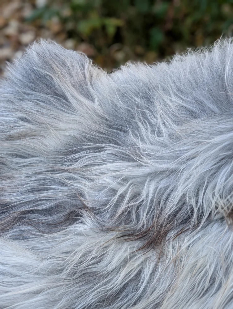 A soft fluffy gray wool icelandic rug with long wool icelandic texture measuring 59 by 35 inches