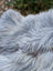 A soft fluffy gray wool icelandic rug with long wool icelandic texture measuring 59 by 35 inches