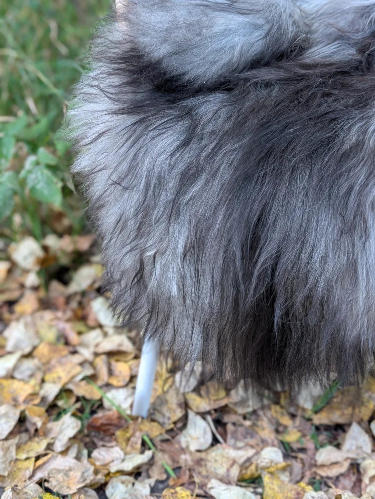 A massive icelandic sheepskin coat with gray and black faux fur and a soft voluminous texture