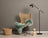 Wicker butterfly chair with black metal legs draped in teal dyed merino sheepskin throw meeting european standards