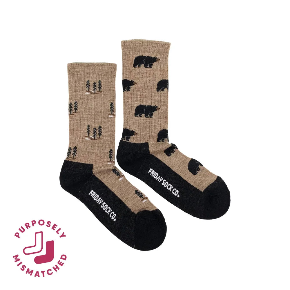 Tan women’s merino wool socks with black bear and pine tree patterns and contrasting black toe and heel