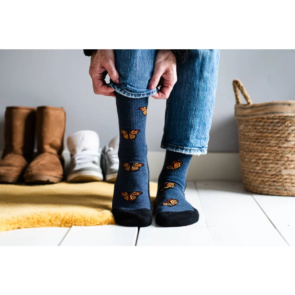 Women’s blue butterfly merino wool socks with orange accents