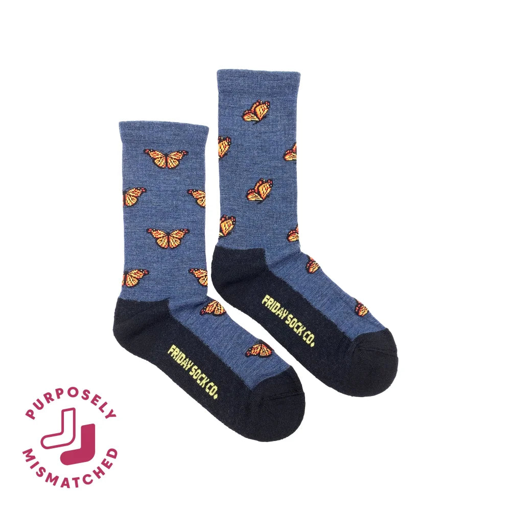 Women’s blue heathered merino wool socks with orange monarch butterfly prints and friday sock co branding on heel