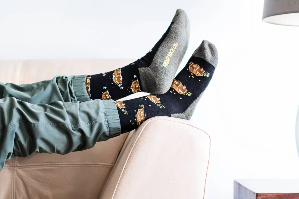 Women’s merino wool cabin socks in black with golden starry spaceships and gray toe caps by angus oliver