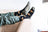 Women’s merino wool cabin socks in black with golden starry spaceships and gray toe caps by angus oliver