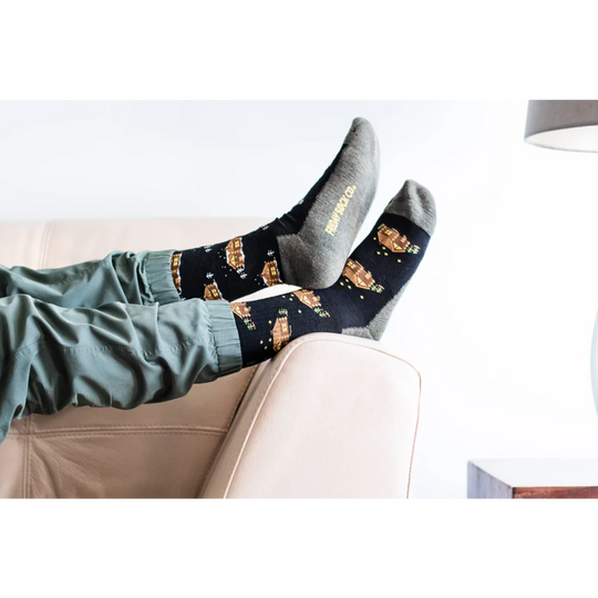 Women’s merino wool cabin socks in black with golden starry spaceships and gray toe caps by angus oliver