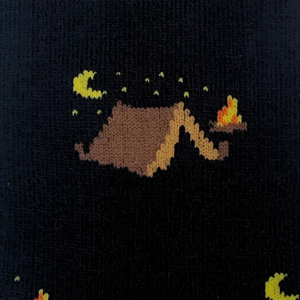 Black knit merino wool sweater with pixelated campsite design featuring brown mountains yellow moons and orange flames