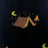 Black knit merino wool sweater with pixelated campsite design featuring brown mountains yellow moons and orange flames