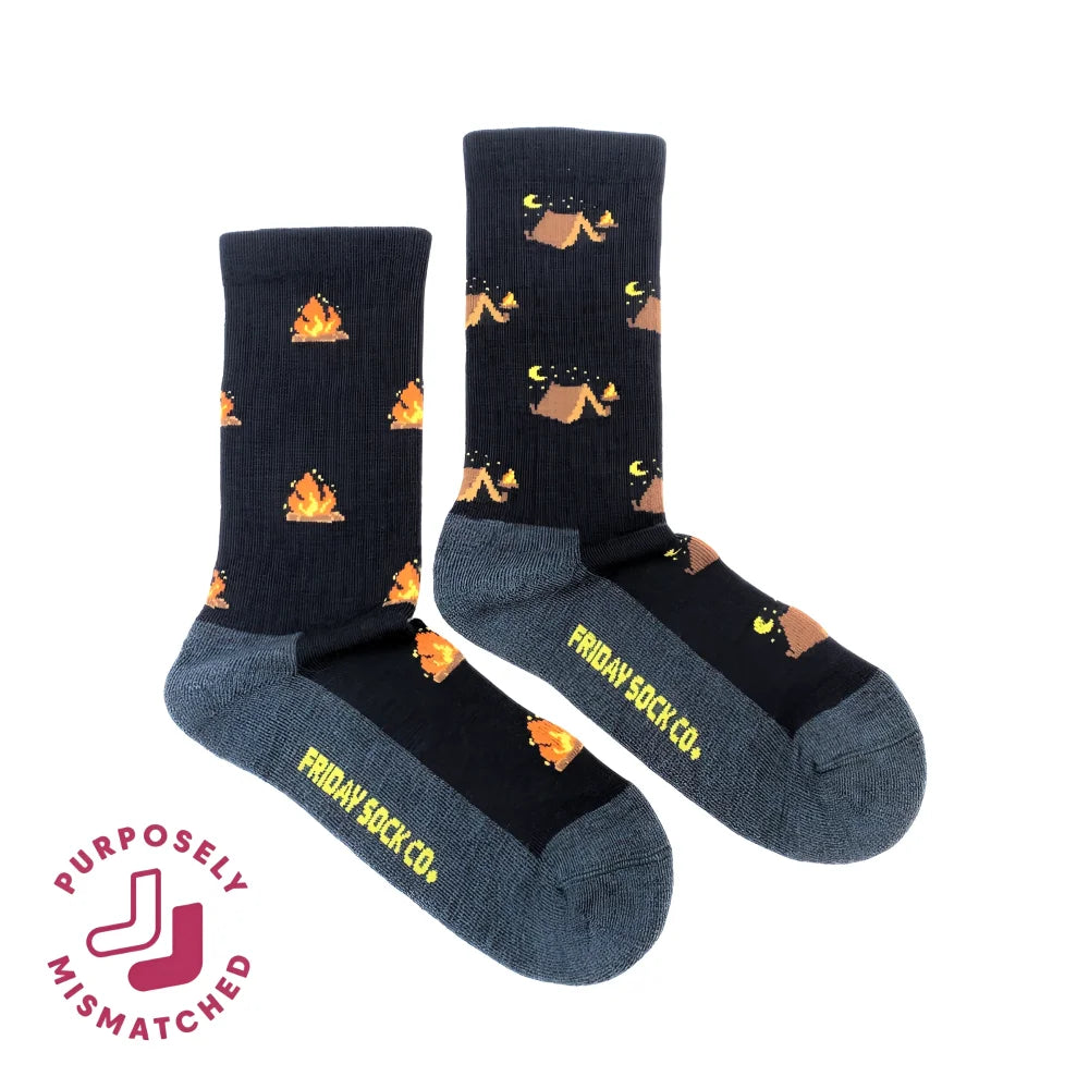 Dark blue women’s camping at night merino wool socks with orange campfires and tan tents perfect for cozy outdoor use