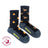Dark blue women’s camping at night merino wool socks with orange campfires and tan tents perfect for cozy outdoor use