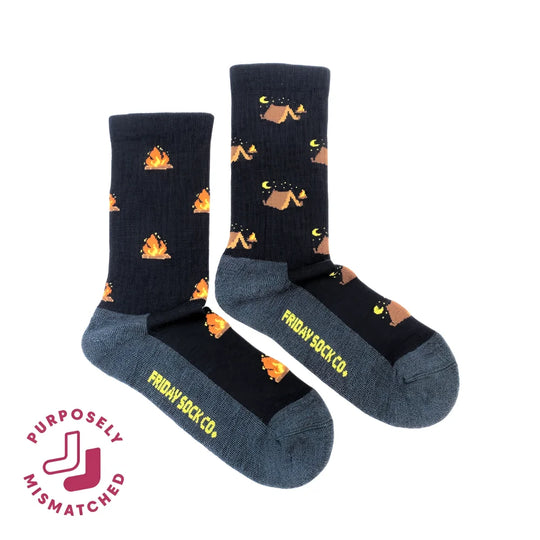 Dark blue women’s camping at night merino wool socks with orange campfires and tan tents perfect for cozy outdoor use