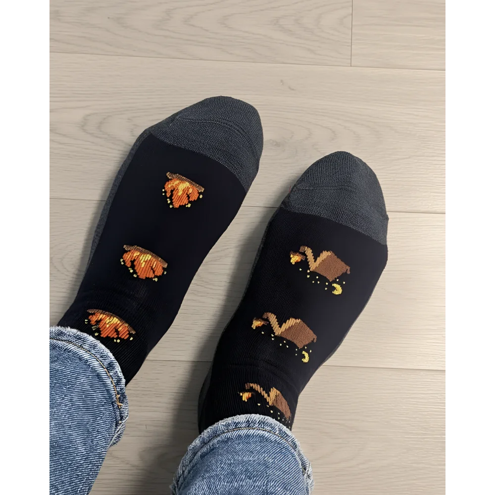 Women’s camping at night merino wool socks in black with gray toes and pixelated orange pumpkin designs by angus oliver