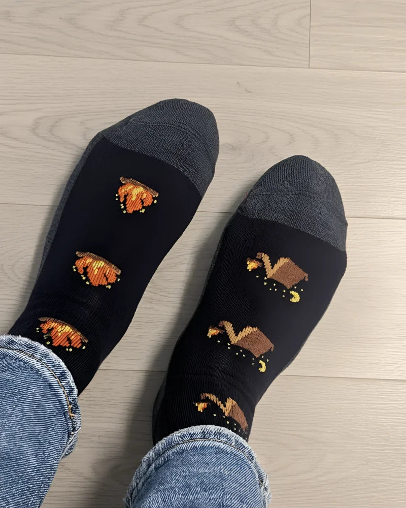 Women’s camping at night merino wool socks in black with gray toes and pixelated orange pumpkin designs by angus oliver
