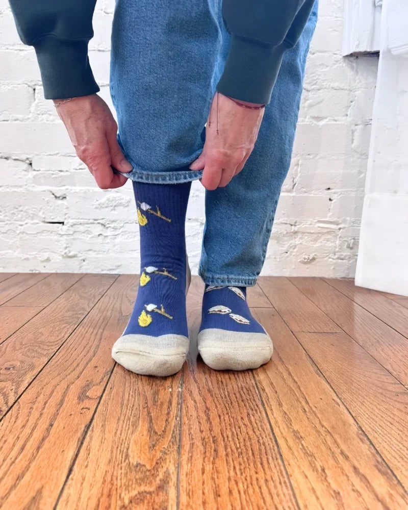 Women’s blue merino wool socks with yellow white bird designs and light gray toe cap perfect for fun outdoor camping
