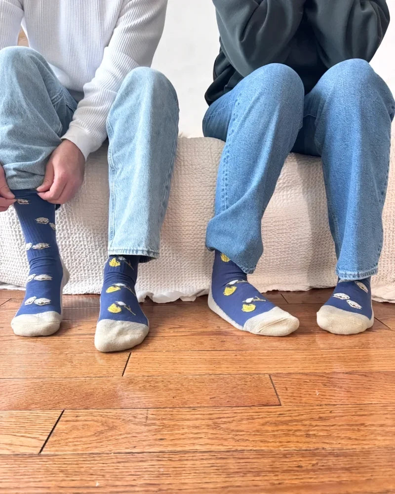 Women’s camping smores merino wool socks in blue with yellow lemons, white clouds, and cream toe and heel accents