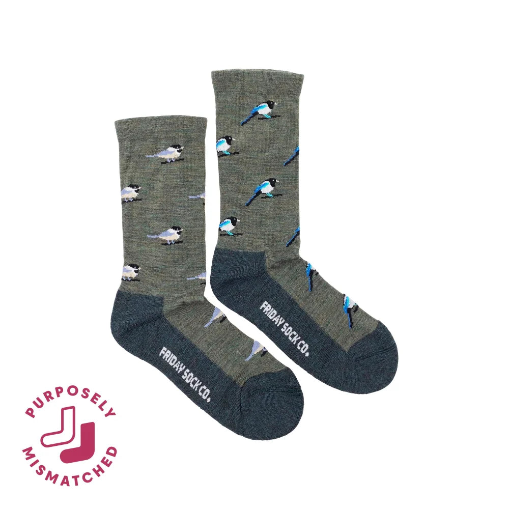 Gray merino wool socks with blue and black magpie pattern and dark gray reinforced toe and heel for hiking