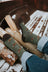 Women’s olive green merino wool socks with brown fox prints and dark brown toes worn with rolled-up jeans