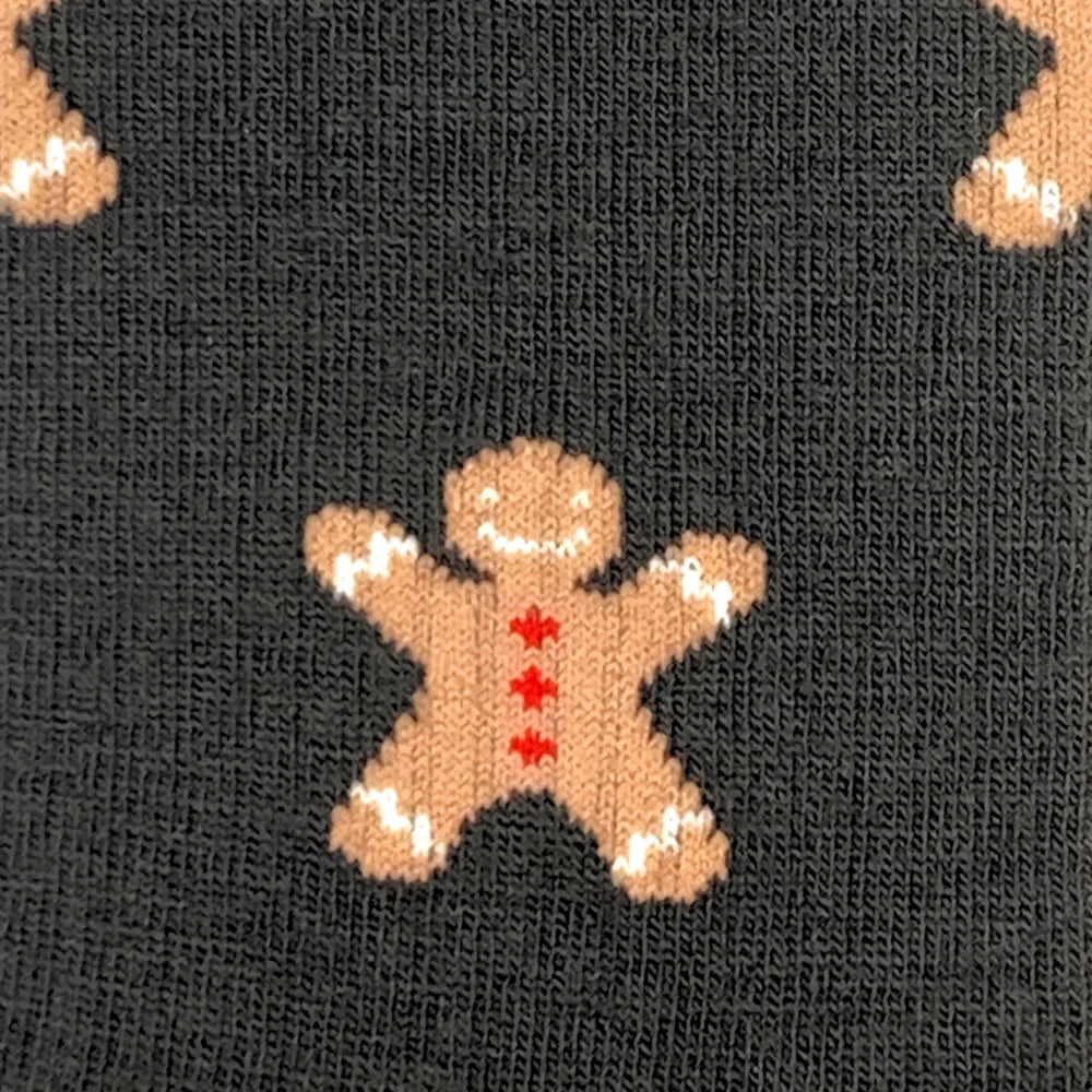 Women’s cozy outdoor merino wool socks with a tan knitted gingerbread man design and red star buttons on dark gray