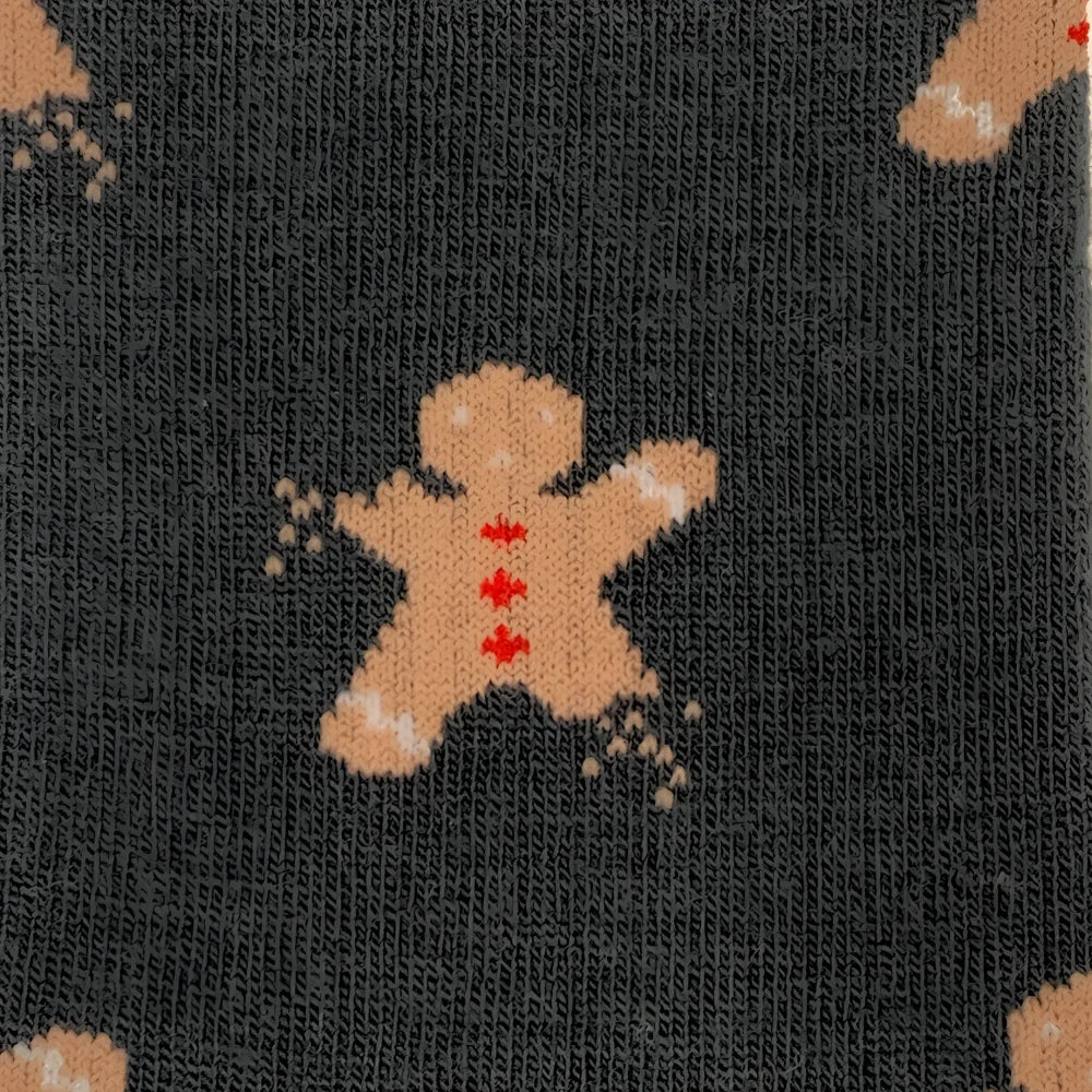 Dark gray merino wool socks for women featuring a tan gingerbread man with red icing and white sugar sprinkle accents