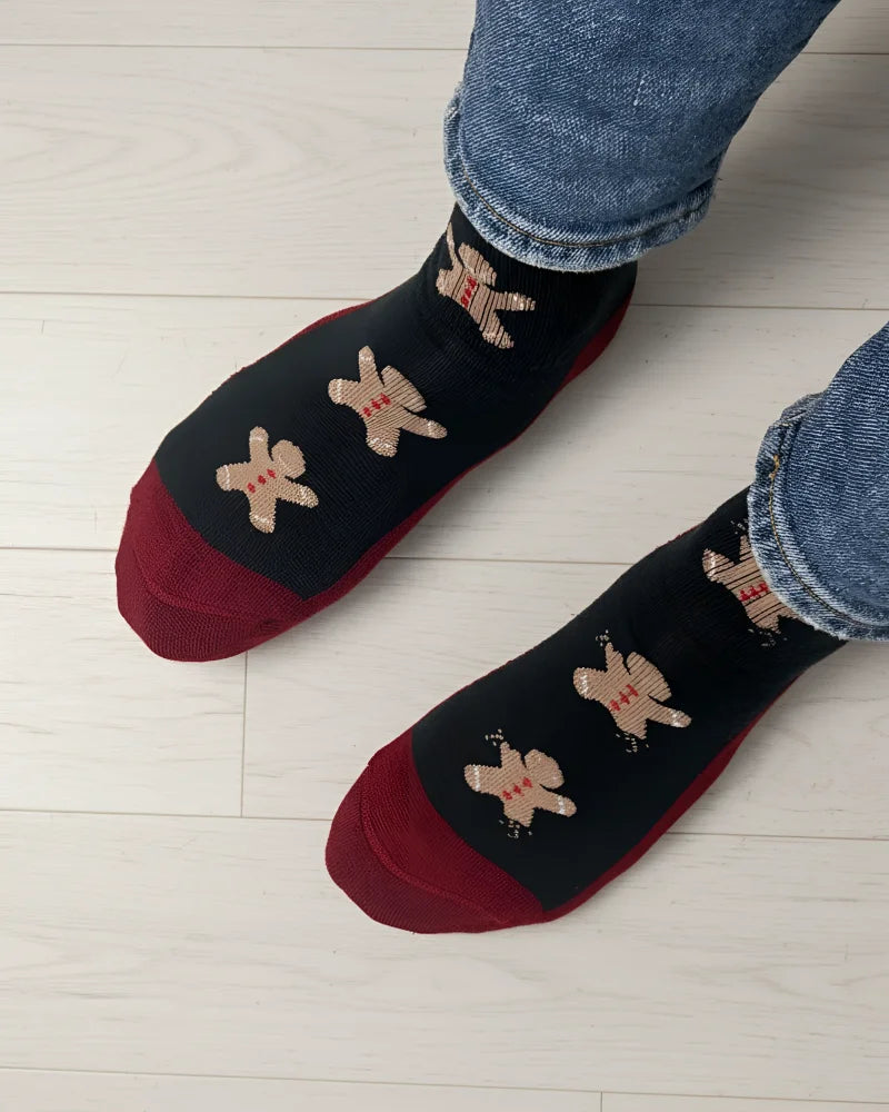 Women’s gingerbread bite merino wool socks in black and red with beige gingerbread men by angus oliver