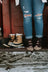 Tan sorel snow boots with black laces and white sole next to ripped jeans paired with breathable merino wool socks
