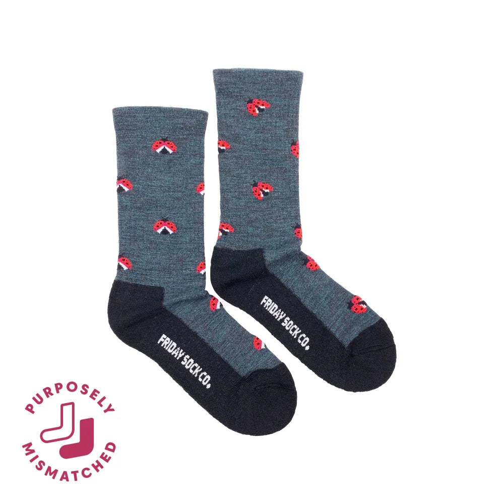 Gray women’s crew socks with red ladybug merino wool pattern and black toe caps by friday sock co