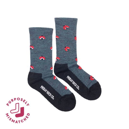 Gray women’s crew socks with red ladybug merino wool pattern and black toe caps by friday sock co