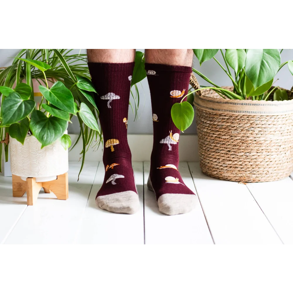 Women’s maroon merino wool socks with embroidered mushrooms and snails ribbed texture and beige toes for hiking