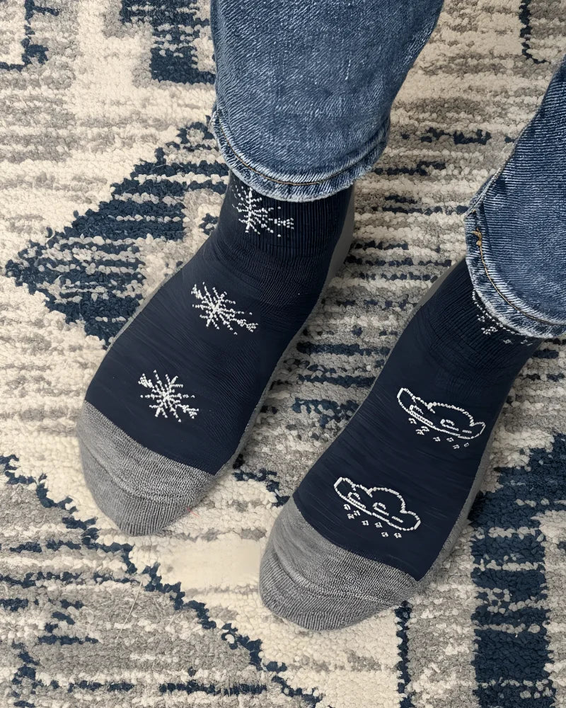 Women’s winter merino wool socks in dark blue with gray toes heels and white snowflake cloud designs by angus oliver