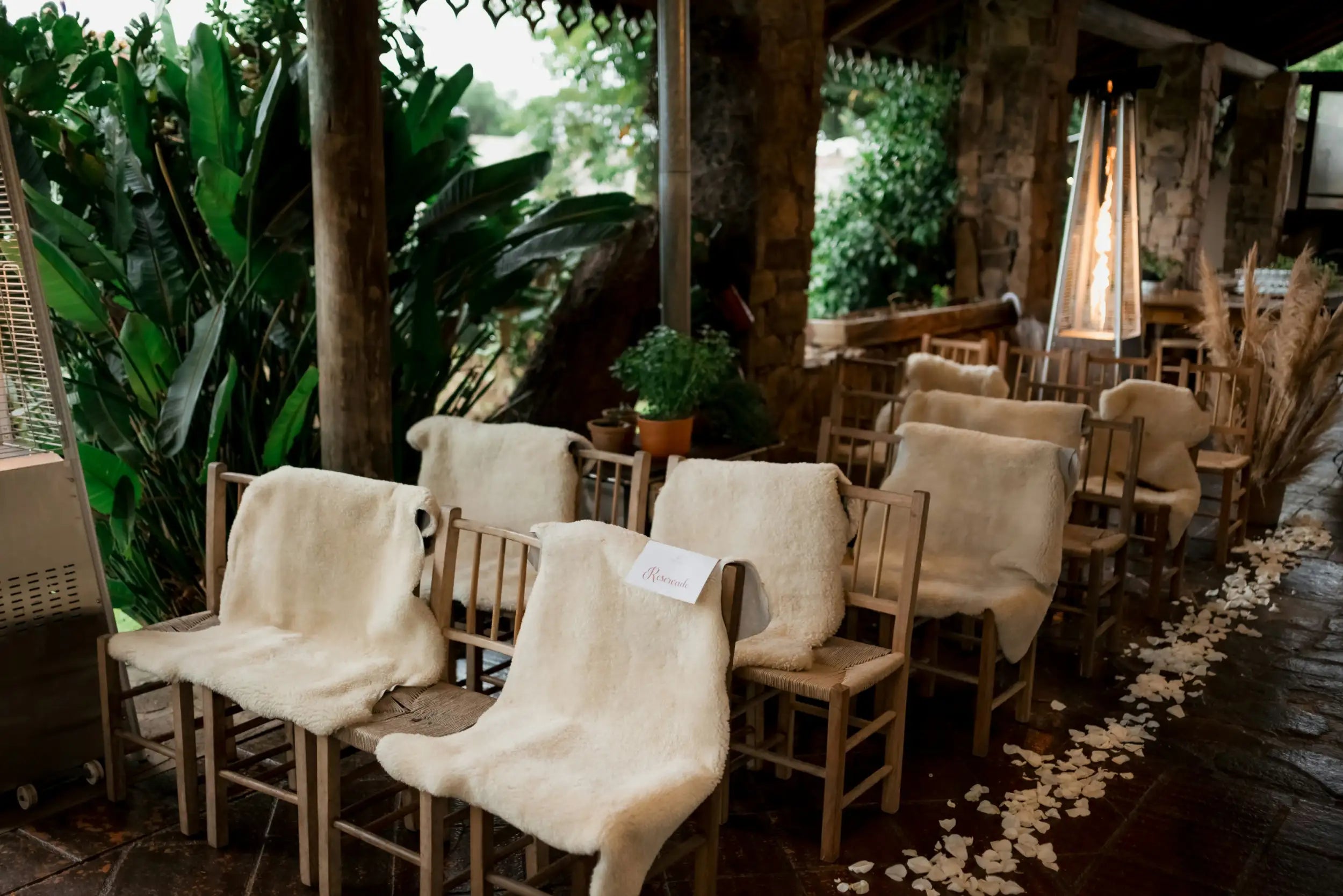 Wooden chairs draped with cream-colored sheepskin blankets.