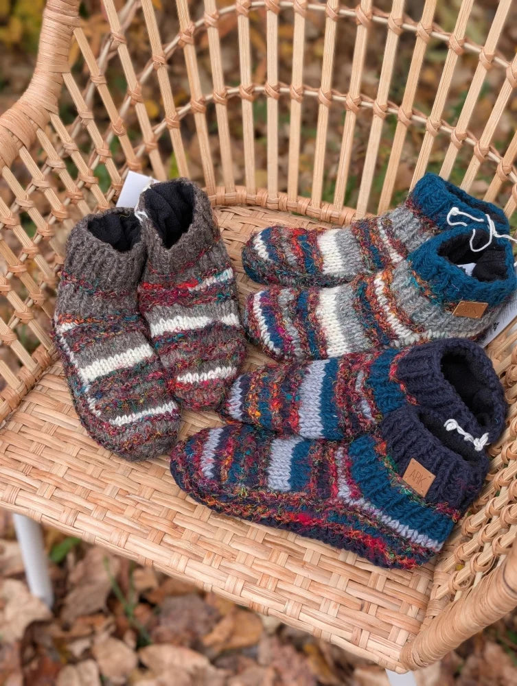 Three pairs of woolen adult sized booties with swool stripe wool pattern and cozy fleece-lined interiors in earthy tones