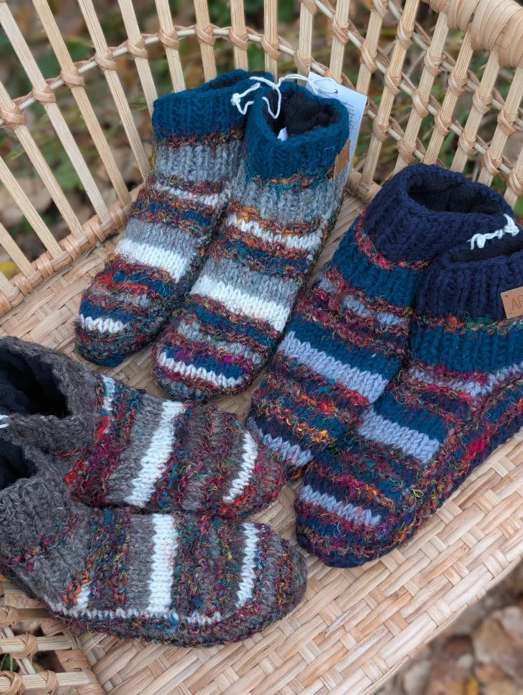 Three pairs of hand-knitted swool stripe wool booties with cozy multicolored stripes and ribbed cuffs for adults