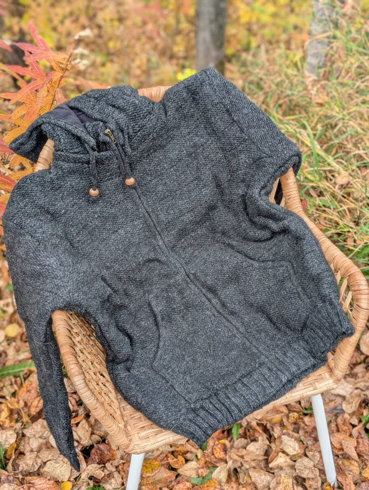 Dark gray textured knit calgary cardigan with attached hood wooden toggle pulls and ribbed cuffs made from zealand wool
