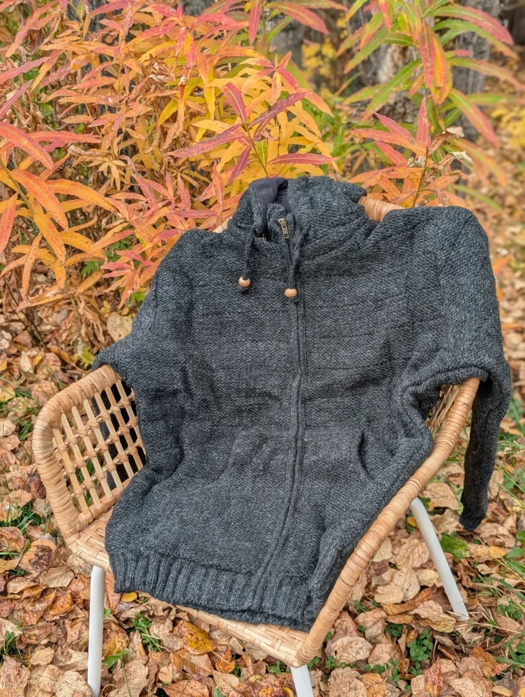 Dark gray woolen calgary cardigan with attached hood wooden toggle drawstrings and ribbed cuffs made from zealand wool